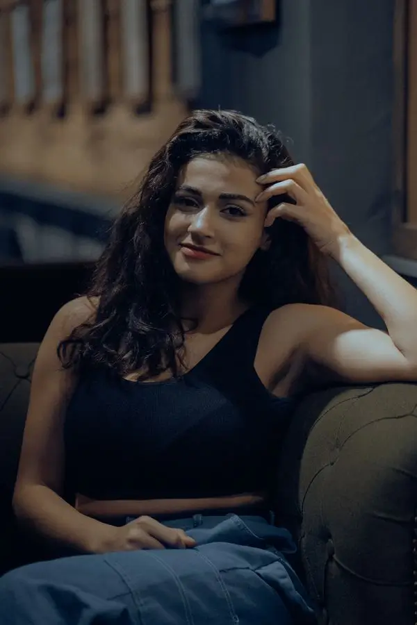 Anamika greater Noida call girls sofa portrait with curly hair